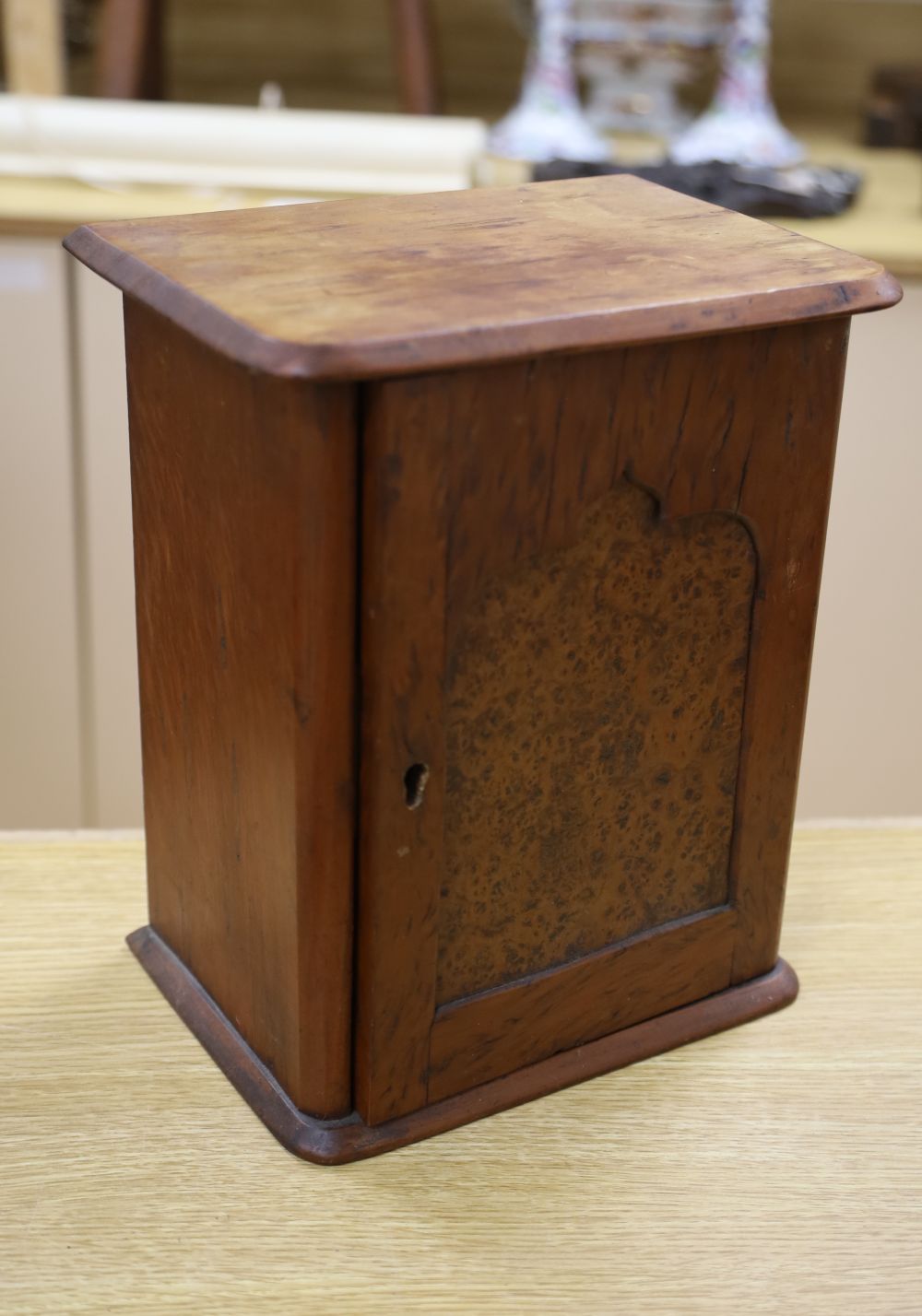 A late Victorian burr yew table-top cupboard, with five enclosed drawer veneered in a variety of timbers, width 22cm, and three cast